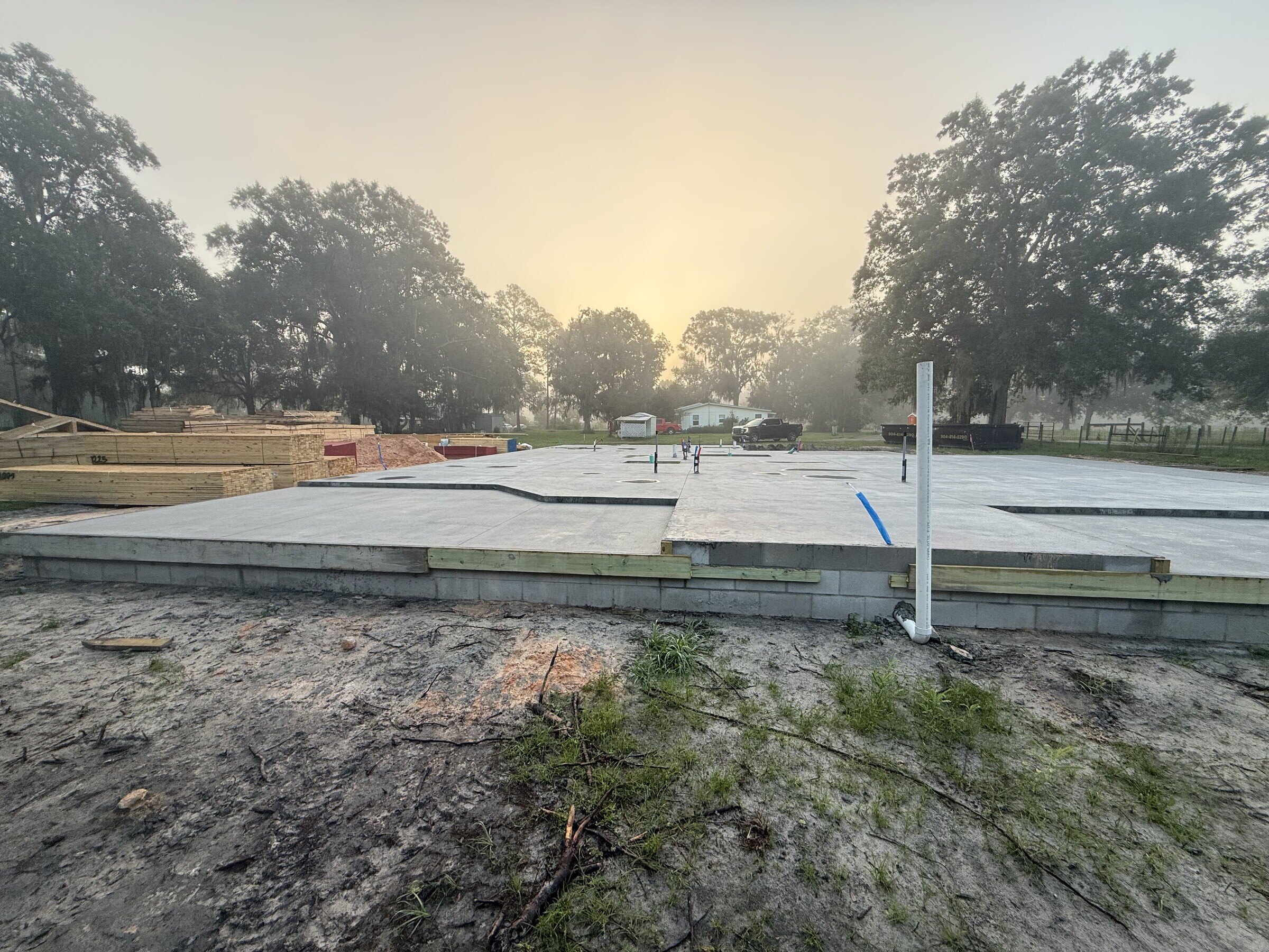 Wide view of the finished concrete foundation slab for a Starke area custom home